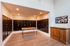Modern apartment mailroom with sleek black mailboxes, hardwood floors, and cozy lighting, offering convenience and style.
