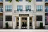 Charming apartment exterior featuring elegant brickwork and large windows, inviting entrance at Highland Station.
