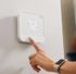 Modern smart thermostat with user-friendly touch controls set to 72 degrees, highlighting energy efficiency and sleek design.