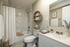 Elegant bathroom featuring a marble-tiled shower, modern white fixtures, and stylish wood accents, creating a serene and inviting space.