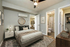 Cozy bedroom featuring modern decor, plush bedding, and a stylish en-suite bathroom.