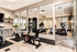Modern gym with sleek exercise bikes and state-of-the-art equipment, offering a bright and inviting workout space with mirrored walls and contemporary design.