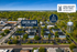 Aerial view of Overland Station apartments surrounded by lush greenery, with a prominent water tower nearby, showcasing a vibrant community just a 2-minute walk from downtown Overland Park.