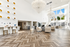 Luxurious, bright apartment lobby with elegant chandeliers, modern decor, and expansive windows offering natural light.