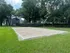 Inviting sand volleyball court surrounded by lush greenery and trees, perfect for outdoor activities and relaxation.