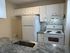 Modern kitchen featuring elegant countertops, sleek white cabinetry, and a stylish backsplash with essential appliances.