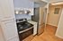 Contemporary kitchen with stainless steel appliances, sleek countertops, and elegant white cabinetry.