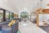 Luxurious open-concept living space with modern decor, high vaulted ceilings, and elegant lighting accents.
