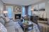 Chic living room featuring a cozy fireplace, stylish artwork, and elegant decor with modern furniture.