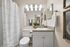 Elegant bathroom with chic lighting, stylish vanity, and modern decor, exuding comfort and sophistication.