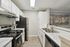Modern kitchen with sleek stainless steel appliances, elegant white cabinetry, and stylish marble countertops for a luxurious cooking experience.