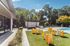 Chic outdoor pool area at Rosemont Chamblee featuring modern seating, lush greenery, and a welcoming lounge ambiance.