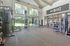 Spacious and modern fitness center featuring state-of-the-art gym equipment, large windows for natural light, and a welcoming environment for a healthy lifestyle.