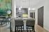 Contemporary kitchen with sleek granite countertops, stylish pendant lighting, and a modern bar setup, perfect for casual dining and entertaining.