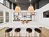 Luxurious modern kitchen with sleek white island, chic bar stools, and elegant pendant lighting.