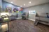 Modern pet grooming station featuring stylish artwork, vibrant lighting, and professional amenities for pet care.