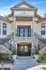 Elegant apartment entrance with grand double doors, charming stone facade, and symmetrical staircases.