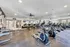 Spacious and well-lit fitness center featuring modern cardio machines and exercise bikes, perfect for a rejuvenating workout.