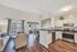 Chic open-concept living space featuring a modern kitchen with stainless steel appliances, bright dining area, and cozy living room with stylish decor.