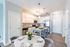 Sleek kitchen with modern appliances, elegant marble dining table set for four, and chic pendant lighting.