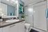Bright and modern bathroom with sleek finishes, featuring a spacious shower, elegant sink, and stylish decor.