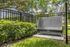Tranquil outdoor dog washing station surrounded by lush greenery and stylish fencing, perfect for pet-friendly living.