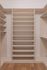 Spacious walk-in closet featuring elegant shelving and ample storage space.