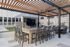 Modern outdoor patio with stylish pergola, elegant bar seating, and sleek built-in TV, perfect for entertaining.