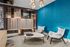 Chic and modern lounge area with plush seating, ambient lighting, and vibrant blue accent wall.