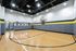 Modern indoor basketball court with sleek design and ample lighting, perfect for energetic games and practice.