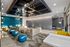 Contemporary lounge area with chic furniture, bold blue accents, and exquisite lighting for a modern ambiance.