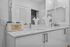 Sleek, modern bathroom with elegant double sinks, chic white cabinetry, and stylish decor accents for a luxurious touch.