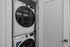 Sleek and modern apartment with built-in stackable washer and dryer, showcasing convenience and space-saving design.