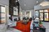 Contemporary and inviting Office with high ceilings, featuring a stylish fireplace, modern artwork, plush seating, and abundant natural light.
