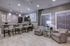 Modern open-plan living area with stylish pendant lighting, sleek kitchen bar, and cozy seating, perfect for entertaining.