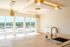Luxurious high-rise apartment interior showcasing expansive windows, modern light fixtures, and a sleek marble kitchen island with brass faucet.