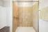 Modern bathroom with elegant tiled shower and sleek fixtures, promising a luxurious and relaxing experience.