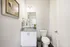 Modern bathroom with elegant granite countertop, bright lighting, and stylish decor, offering a serene space for relaxation.