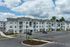Elegant modern apartment building with spacious balconies and ample parking.