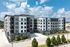 Modern apartment complex with sleek design, featuring large windows and a well-maintained landscape under a clear blue sky.