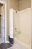 Elegant bathroom with a classic white tub, modern fittings, and a stylish shower curtain, perfect for relaxation and comfort.
