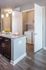 Modern kitchen with elegant granite countertops, pendant lighting, and an adjacent laundry nook for convenience.