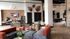 Modern and inviting communal area featuring sleek, contemporary furniture, vibrant decor, and a spacious open layout with stylish wall art and a gourmet kitchen area.
