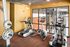 Modern fitness center with state-of-the-art ellipticals and weightlifting equipment, featuring stylish decor and vibrant ambiance.