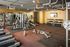 Modern fitness center featuring state-of-the-art equipment, vibrant color scheme, and spacious workout area.
