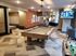 Elegant apartment recreation room featuring a chic pool table, cozy seating area, and flat-screen TV, perfect for entertainment and relaxation.