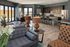 Elegant open-concept living space with cozy seating, modern kitchen, and large windows offering abundant natural light.