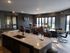 Modern apartment interior with elegant open-concept living area, stylish kitchen island, and chic dining space filled with natural light.