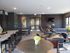 Chic communal lounge featuring a modern design with a ping pong table, stylish seating, and elegant decor for social relaxation.