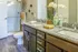 Modern bathroom featuring elegant granite countertops, twin sinks, and chic decorative accents.